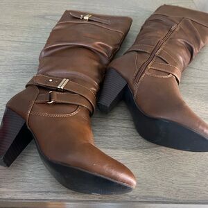 Brown boots with gold embellishment.